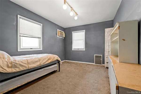 a bed sitting in a bedroom next to a window