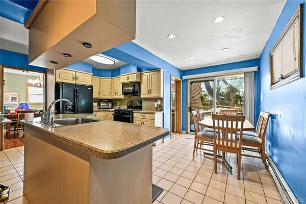 a view of kitchen with dining area a sink and wooden floor