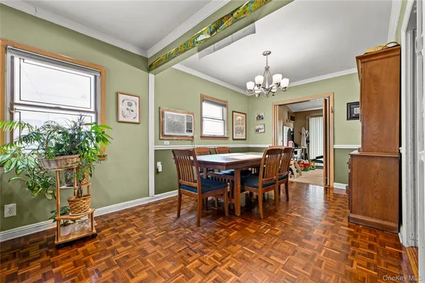 a view of a dining room with furniture and a chandelier