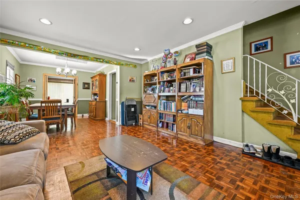 a living room with furniture a dining table and a bookshelf