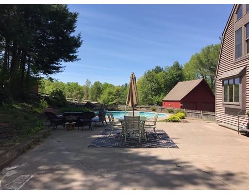 87 Saundersdale Road Charlton, MA 01507 - Photo 28 of 30 a view of a patio with a table and chairs under an umbrella
