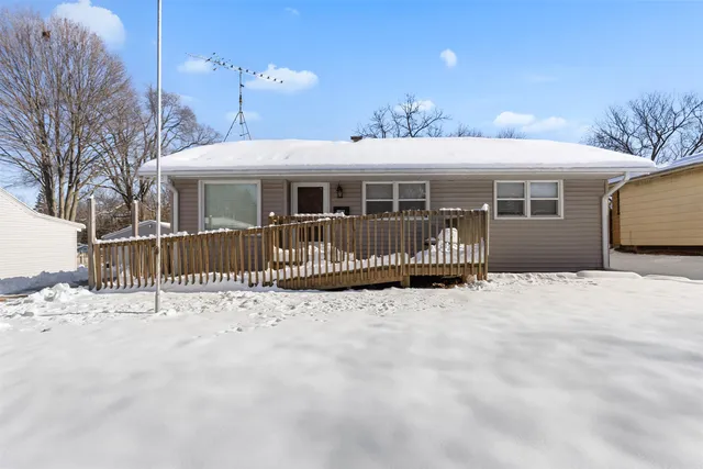 a front view of a house with a wooden deck
