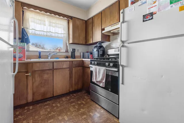 a kitchen with stainless steel appliances a refrigerator sink and cabinets