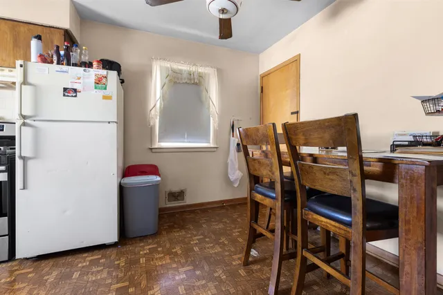a kitchen with stainless steel appliances a refrigerator and a table