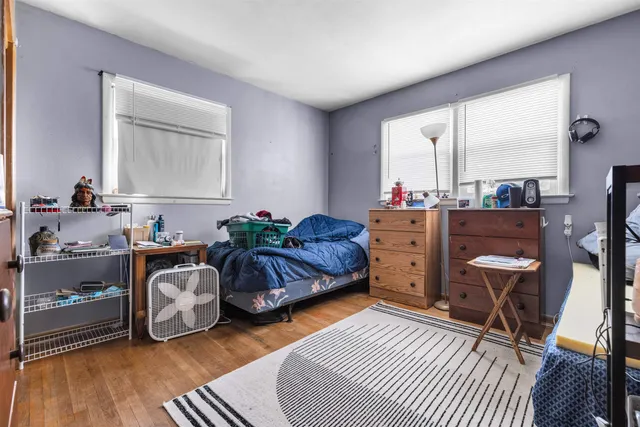a living room with furniture and a dresser
