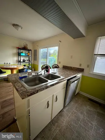 a kitchen with stainless steel appliances granite countertop a sink a stove and a microwave oven