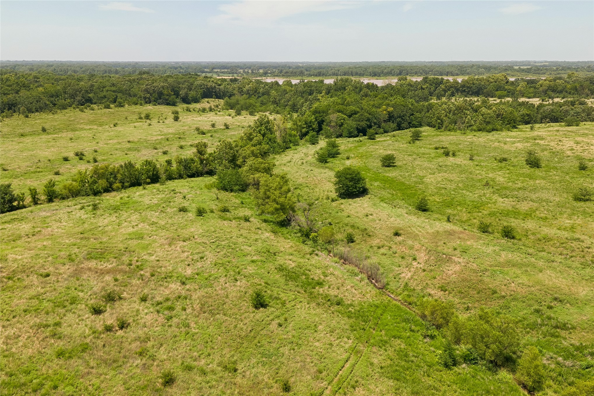 2 West Fern Mountain Road Muskogee, OK 74401 - Photo 21 of 55 Expansive green landscape with a distant tree line and varying terrain