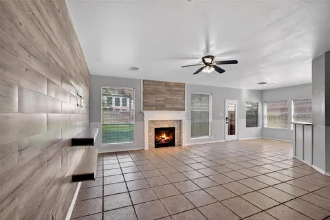 a view of a room with wooden floor and a ceiling fan