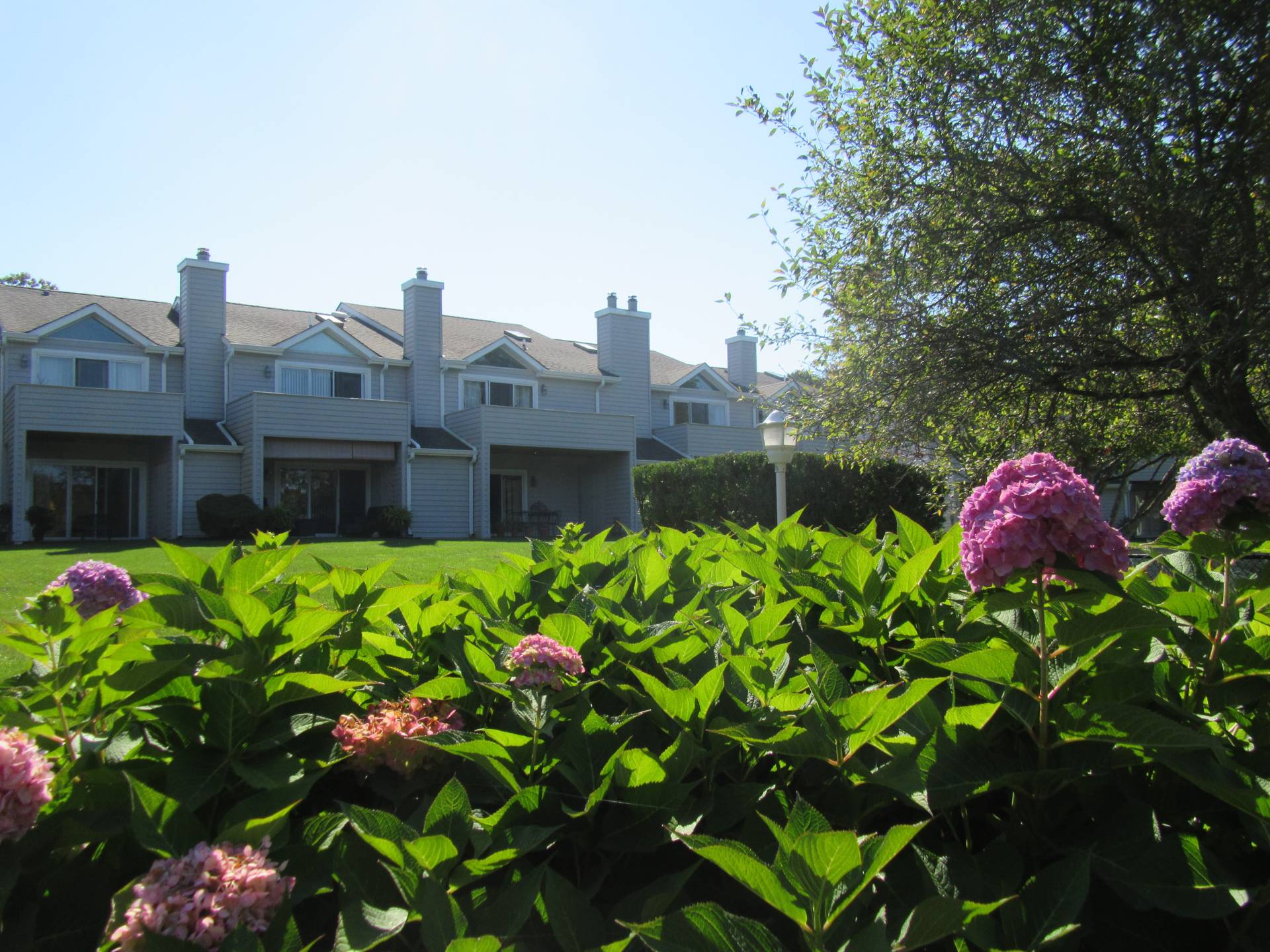 Undisclosed Address Westhampton, NY 11977 - Photo 2 of 18 a front view of a house with a yard and fountain