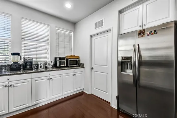 a kitchen with stainless steel appliances a refrigerator sink and cabinets
