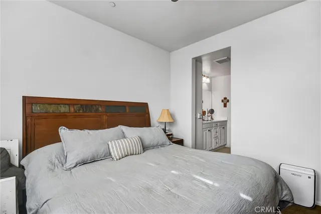 a bedroom with a bed and dresser