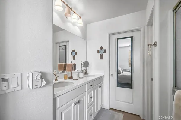 a bathroom with a double vanity sink and mirror