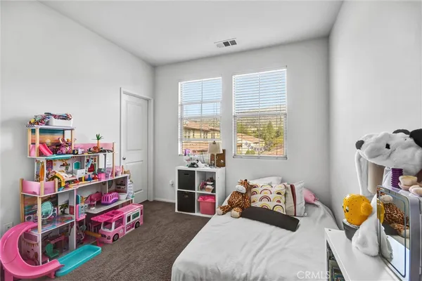 a bedroom with bed and a window