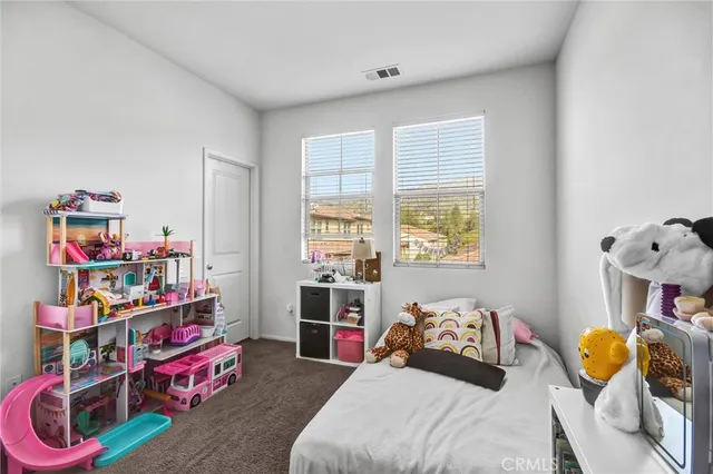 a bedroom with bed and a window