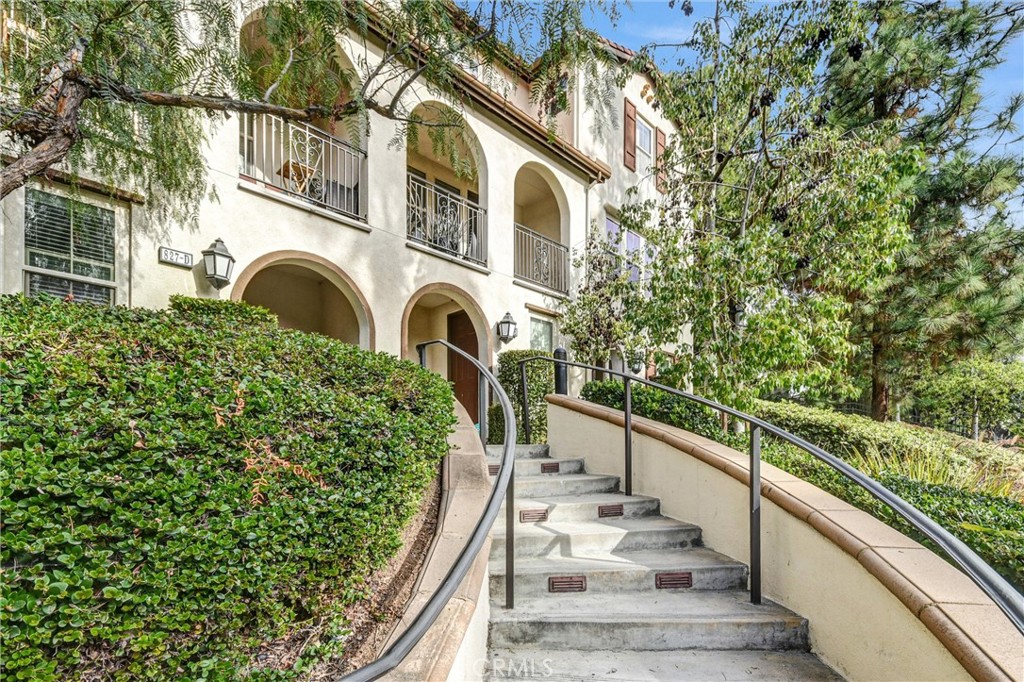827 East Promenade, Unit E Azusa, CA 91702 - Photo 2 of 32 a view of a house with fountain and large trees