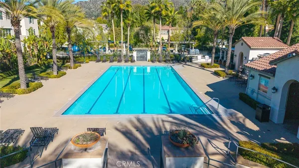 an aerial view of a residential apartment building with a yard and garden