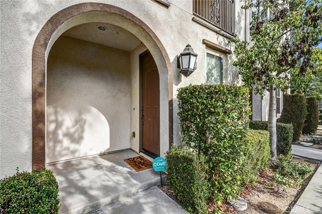 827 East Promenade, Unit E Azusa, CA 91702 - Photo 4 of 32 a front view of a house with a garden