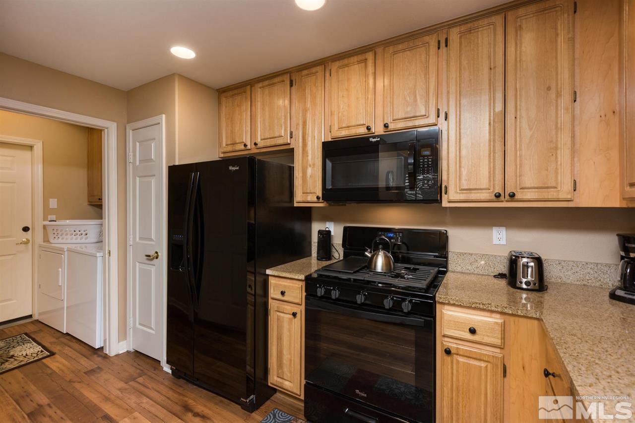 900 S, Unit 3114 Reno, NV 89521 - Photo 4 of 18 a kitchen with granite countertop a refrigerator stove and microwave