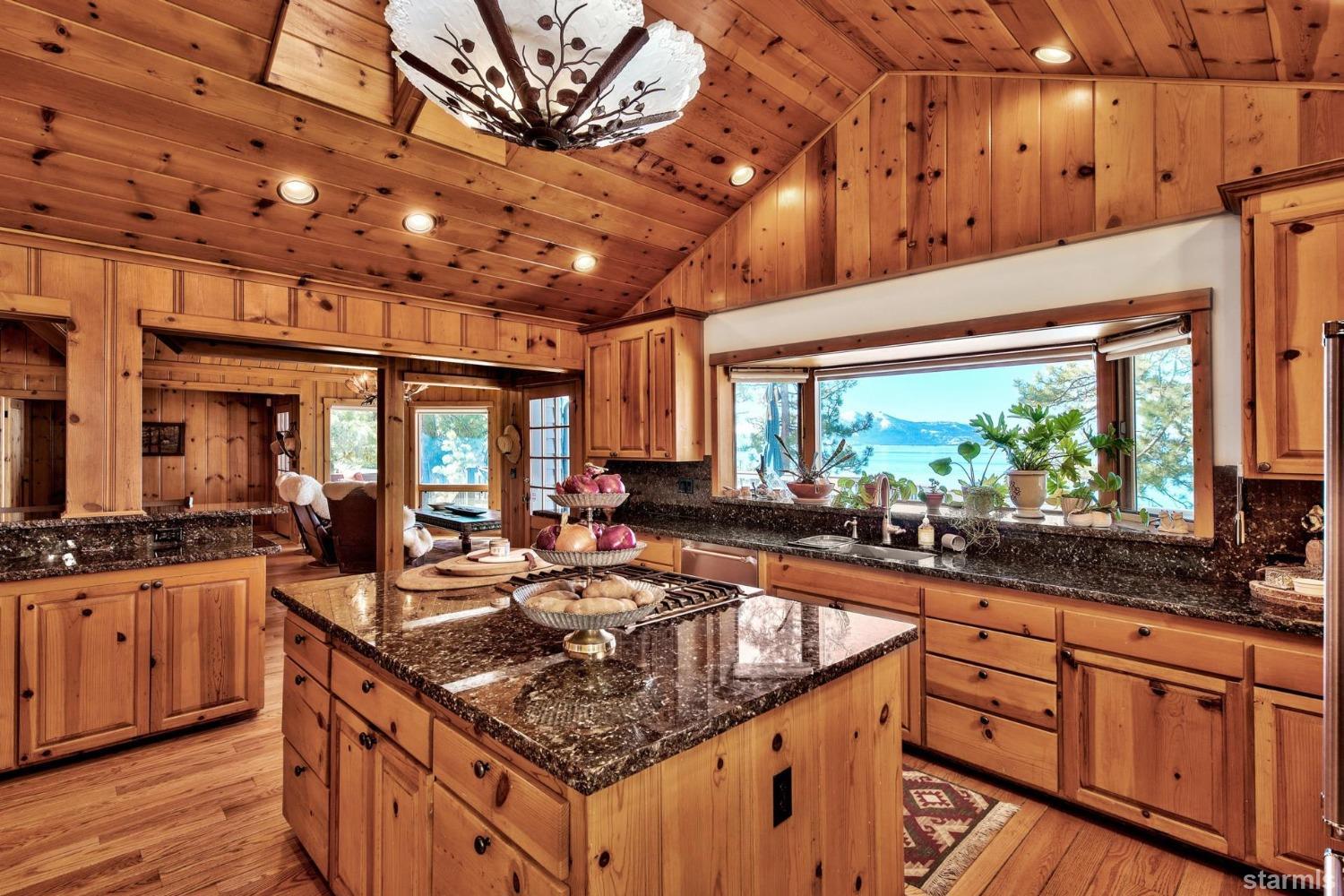 1472 Flowers Glenbrook, NV 89413 - Photo 20 of 25 a kitchen with stainless steel appliances granite countertop a sink a stove and a wooden cabinets