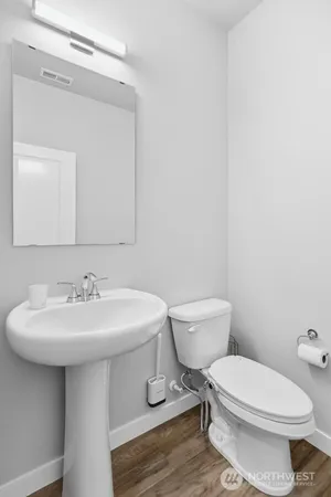 a white toilet sitting next to a bathroom sink