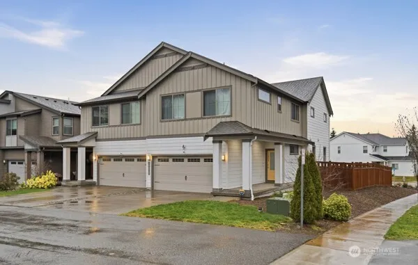 a front view of a house with a yard and garage
