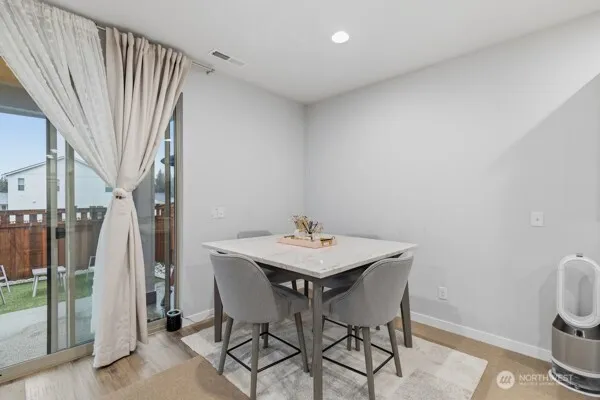 a view of a room with furniture and wooden floor