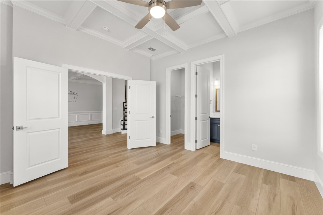141 Rickys Path Easley, SC 29642 - Photo 25 of 40 Bright and airy living space showcasing durable hardwood flooring and elegant coffered ceilings.