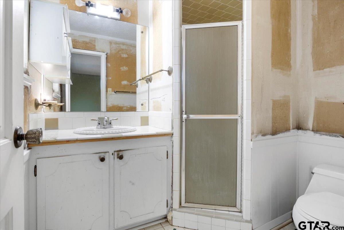1302 Jeb Stuart Drive Tyler, TX 75703 - Photo 22 of 47 a bathroom with a granite countertop sink toilet and shower