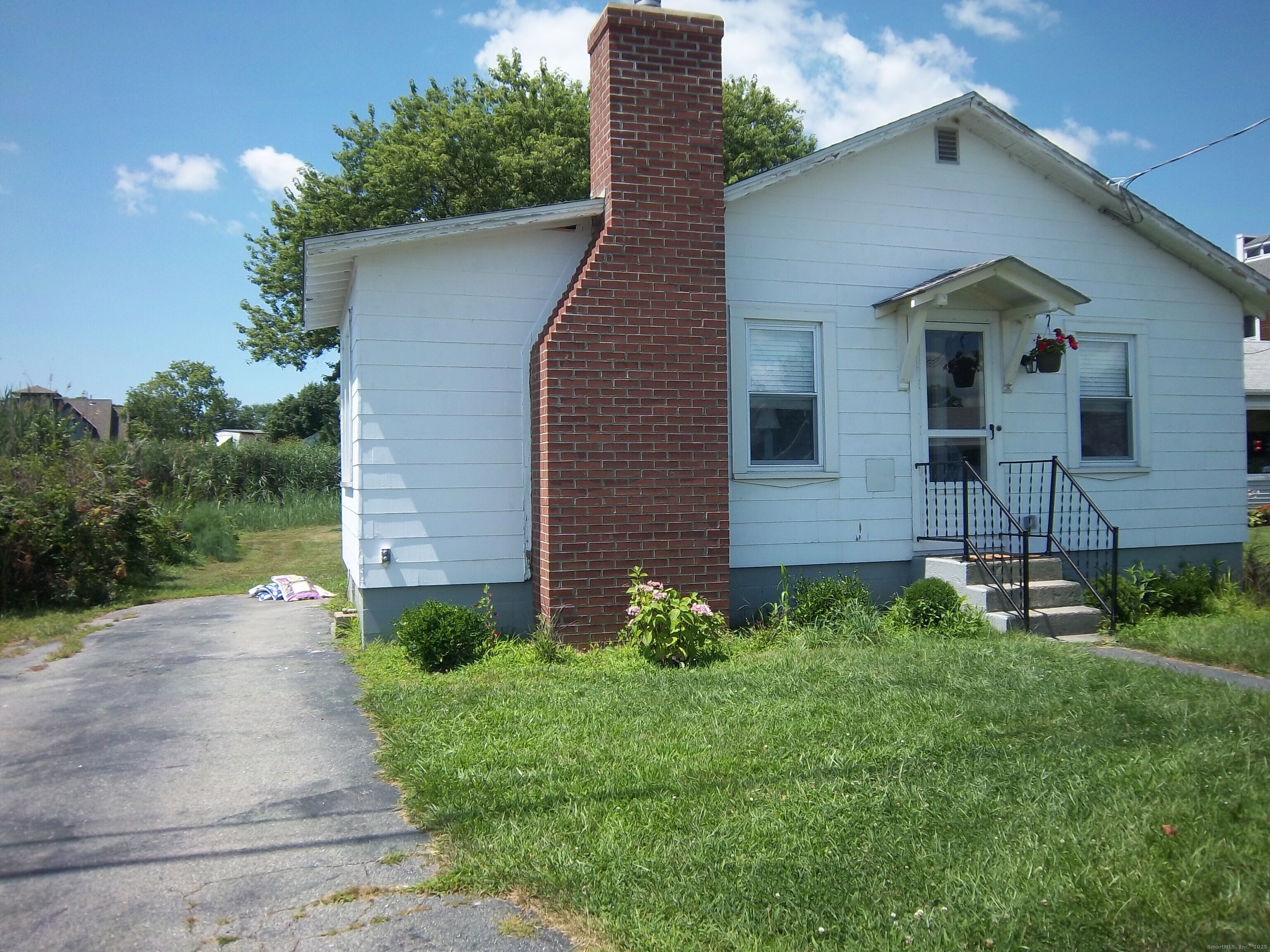 55 Pine Island Road Groton, CT 06340 - Photo 1 of 1 a front view of a house with garden