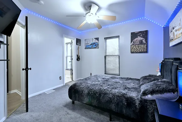 a bedroom with a bed and a chandelier