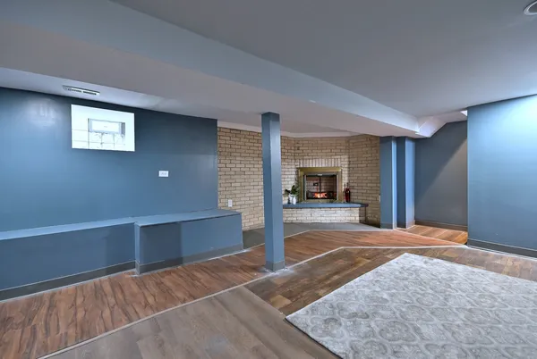 a view of a livingroom with an empty space and a fireplace