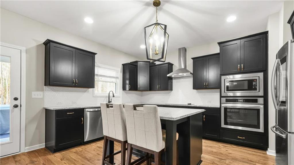 435 Paynes Lake Road Carrollton, GA 30116 - Photo 4 of 11 a kitchen with stainless steel appliances granite countertop a refrigerator and a stove top oven