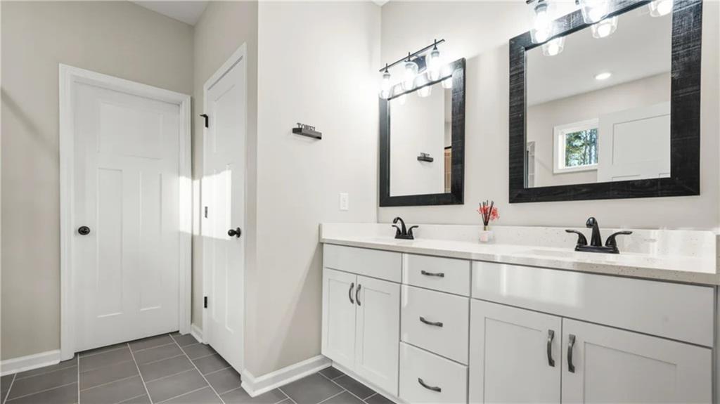435 Paynes Lake Road Carrollton, GA 30116 - Photo 5 of 11 a bathroom with a double vanity sink and mirror