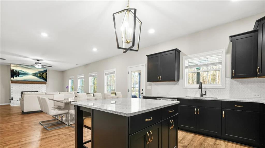 435 Paynes Lake Road Carrollton, GA 30116 - Photo 7 of 11 a kitchen with stainless steel appliances granite countertop a sink stove and cabinets