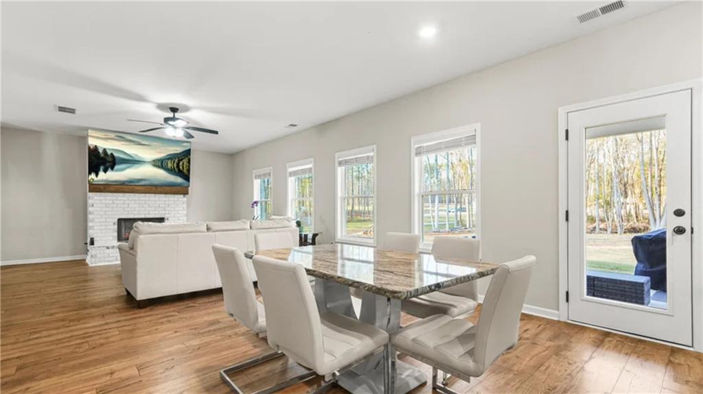 435 Paynes Lake Road Carrollton, GA 30116 - Photo 8 of 11 a view of a dining room with furniture wooden floor and chandelier