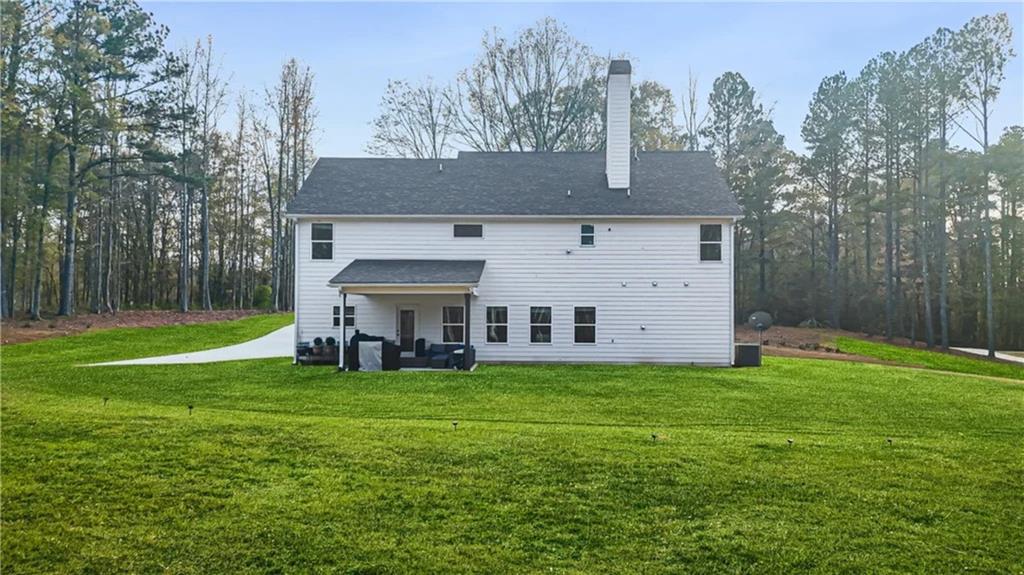 435 Paynes Lake Road Carrollton, GA 30116 - Photo 10 of 11 a view of a house with a big yard and large trees