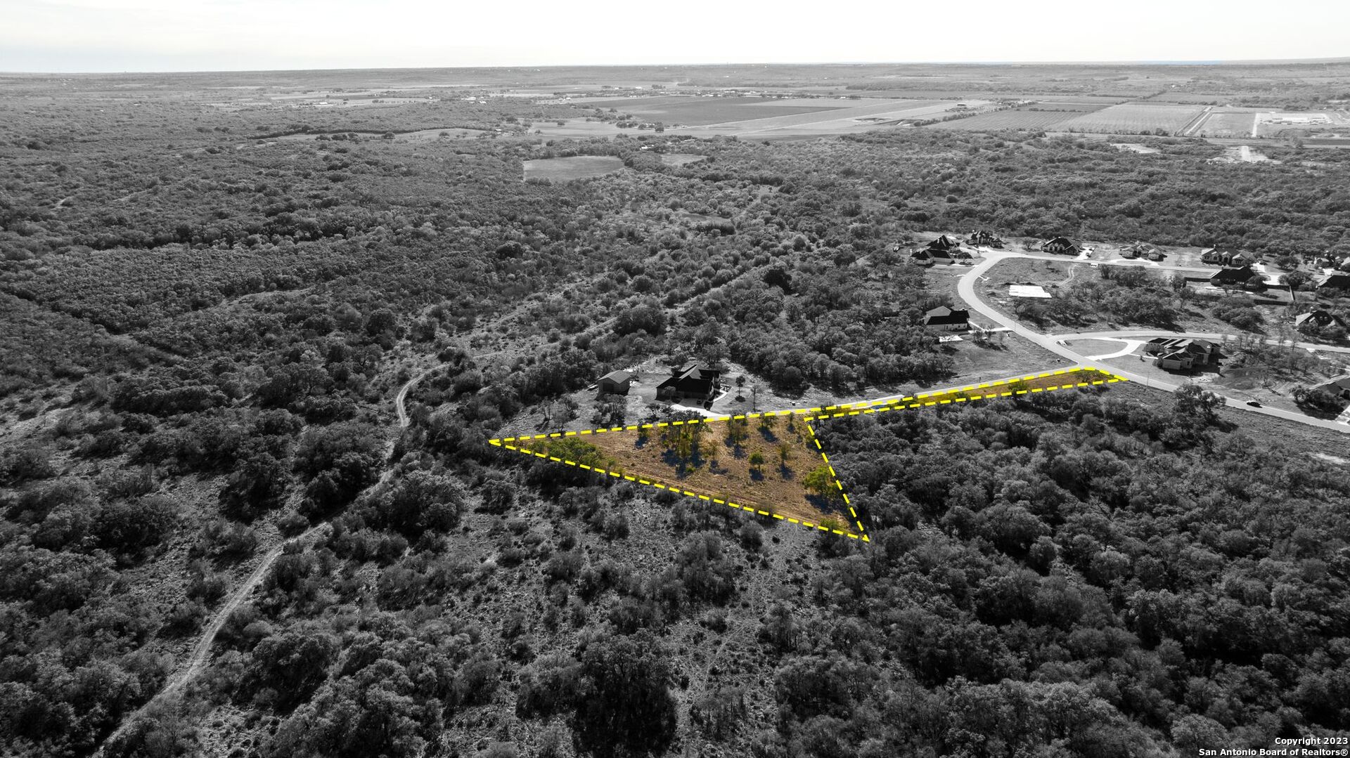 Lot 20 Stone Loop Castroville, TX 78009 - Photo 8 of 17 a view of a dry yard with green space and fog