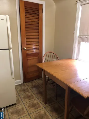 a kitchen with a table and a refrigerator