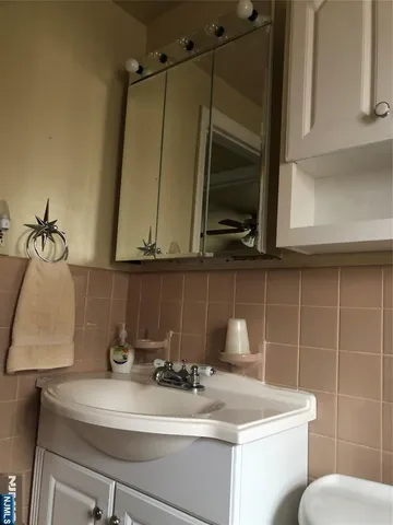 a bathroom with a sink a mirror and vanity