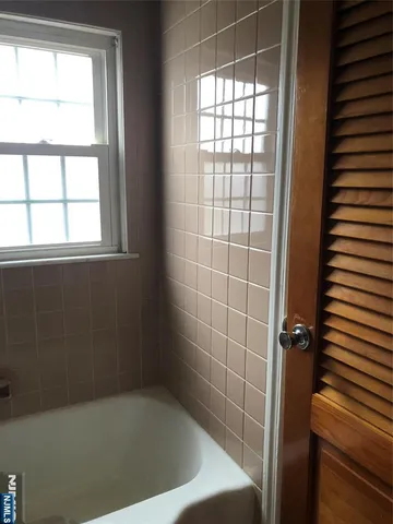 a bath tub sitting next to a window