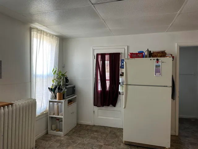 a white refrigerator freezer sitting in a kitchen