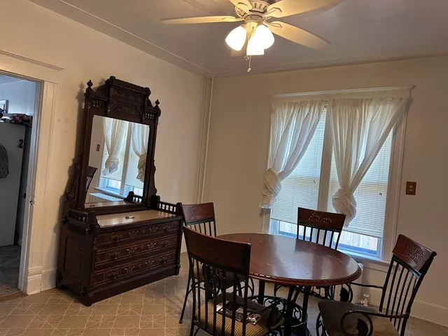 a view of a dining room with furniture and window