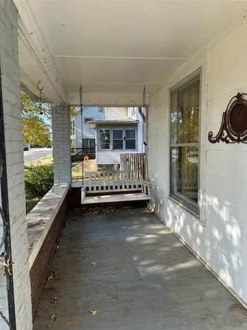 a bedroom with furniture and large window