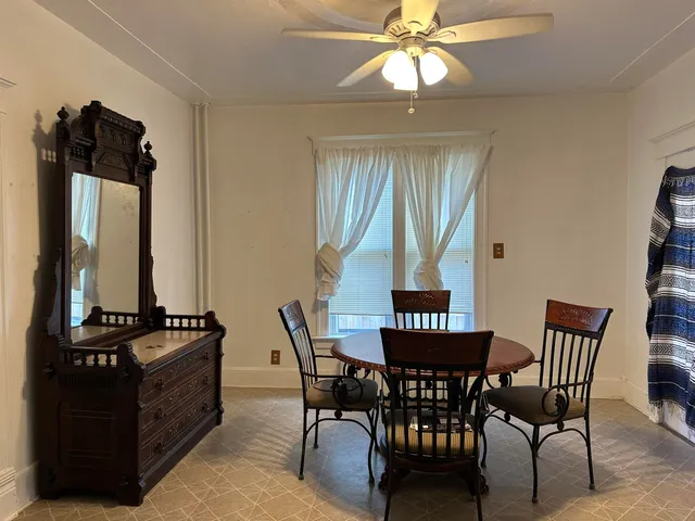 a view of a dining room with furniture and chandelier