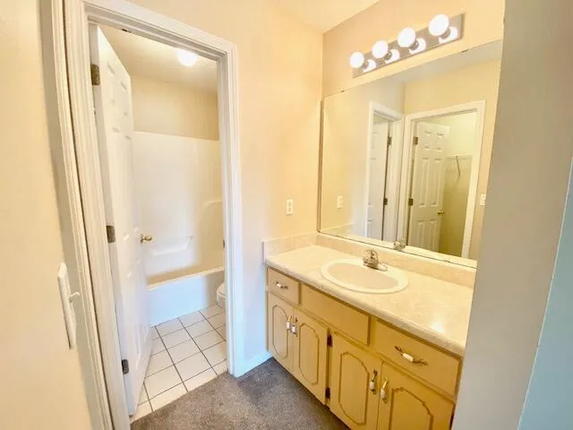 a bathroom with a granite countertop sink mirror and a