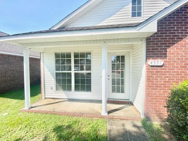 a view of house with backyard