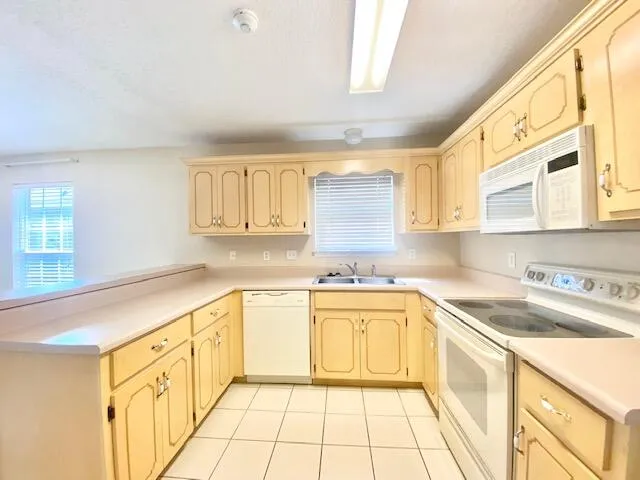 a kitchen with stainless steel appliances granite countertop a sink and cabinets