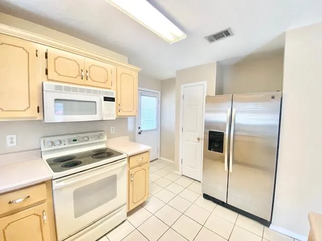 a kitchen with a stove a sink and a refrigerator