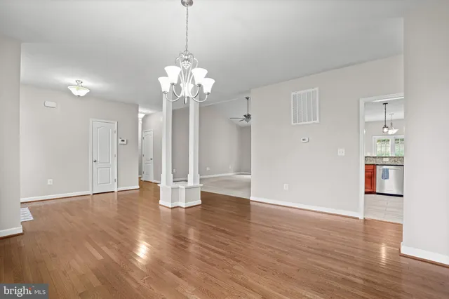 a kitchen with granite countertop a sink a stove and cabinets