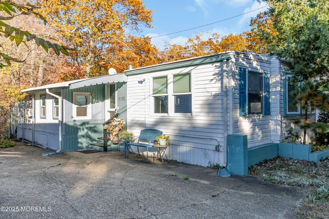a view of a house with a yard and wooden fence
